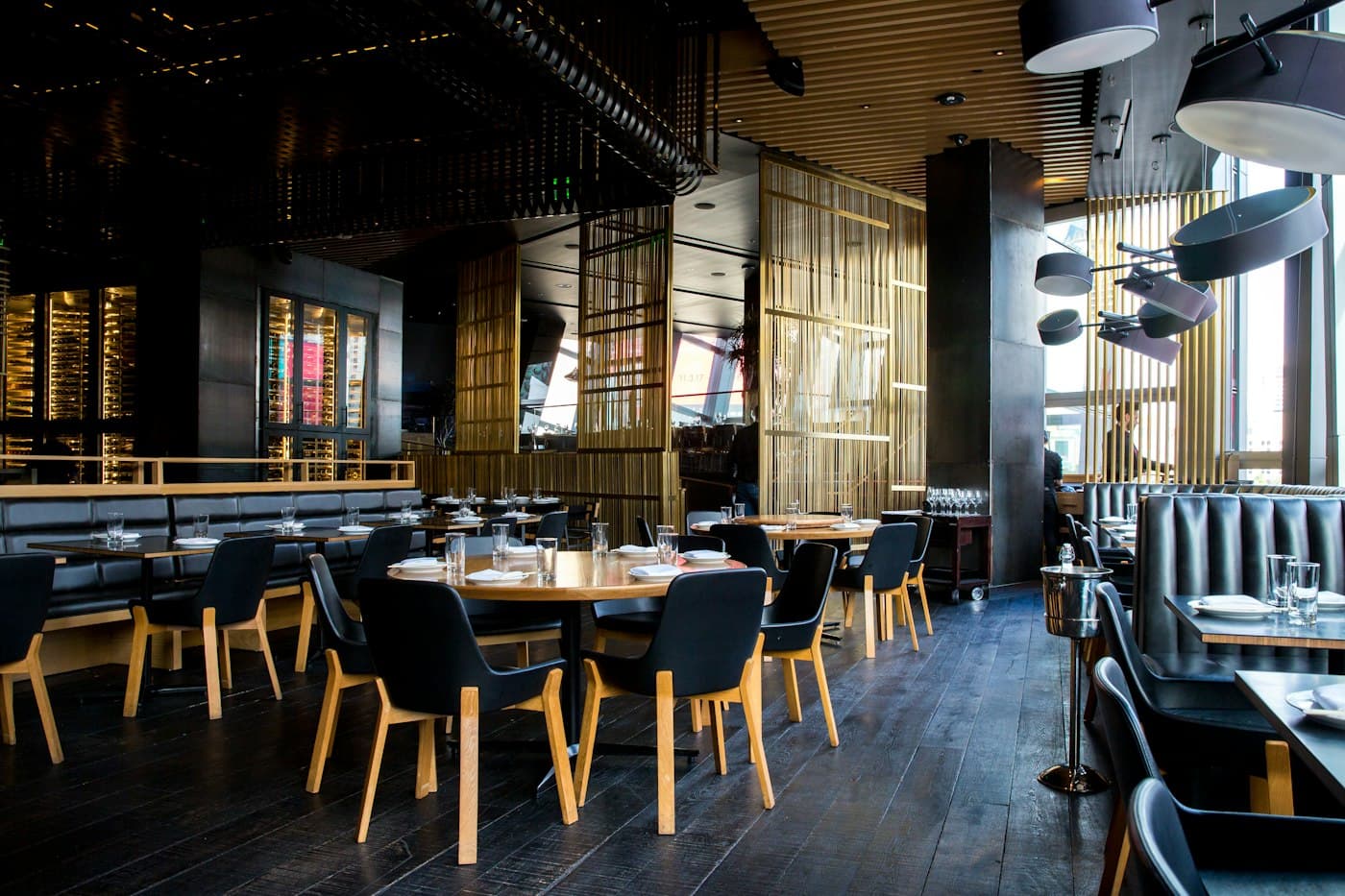 A dining room with set tables and warm lighting